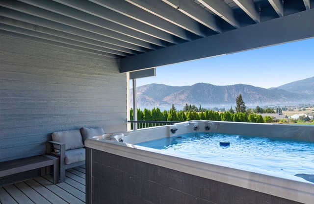 Lake & mountain view home with hot tub, pool, 2 decks, game room, & fireplace