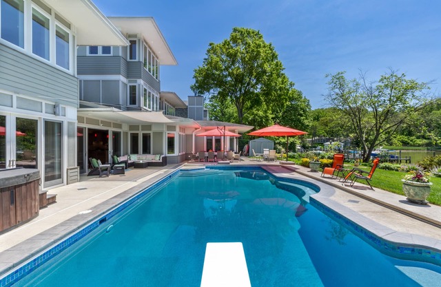 Lakefront home with private pool, hot tub, outdoor space, central AC, & W/D