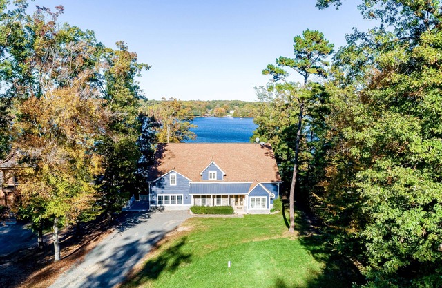 Lakefront home with private hot tub, WiFi, fun rec room, & beach area