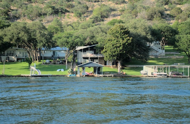 Lakefront retreat on quiet cove with large deck and sweeping views.