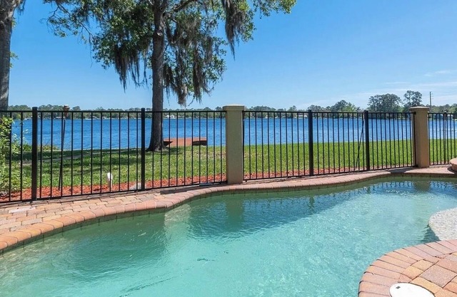 Lakeside Retreat~ Large home with pool, dock, game room and balcony on lakefront