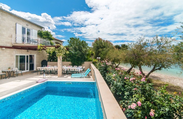 Large family villa with heated pool directly on beach - Sea view from your bed!