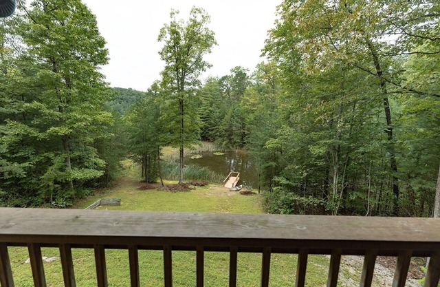 Large Log home, private pond with dock, canoe, pool table, hot tub & internet.