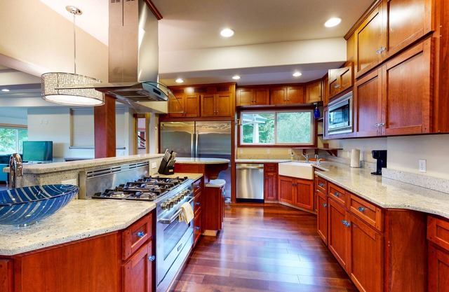 Lovely dwelling with riverfront views, large deck, grill, & patio seating