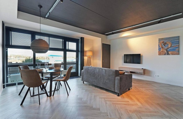 Luxury apartment with private terrace, spacious living room, and stunning view of the Inner Harbor.