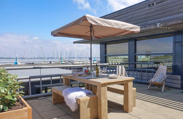 Luxury apartment with private terrace, spacious living room, and stunning views of the marina.
