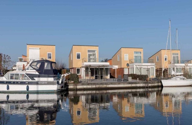 Luxury holiday home with fully hardened waterfront terrace. The long outdoor table under the terrace