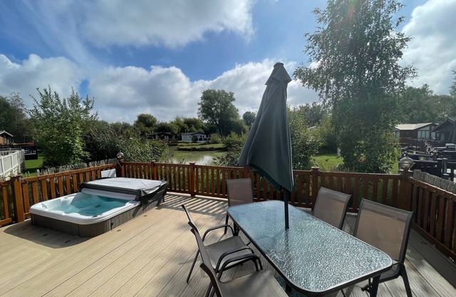 luxury lakeside lodge with a sunken hot tub on bull rush a peaceful feature lake @Tattershall lakes