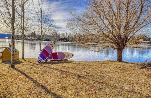 Majestic Lakefront: Dock, Fireplace, Spacious Deck, and Yard, Minutes from Uptown Dining and Trails!