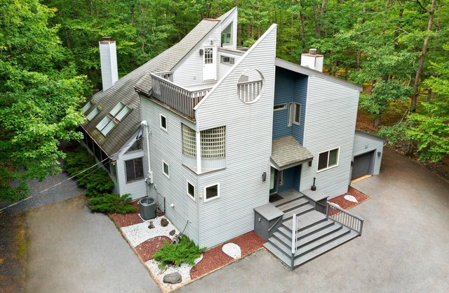 Modern Creek-front House with Volleyball court in the backyard.