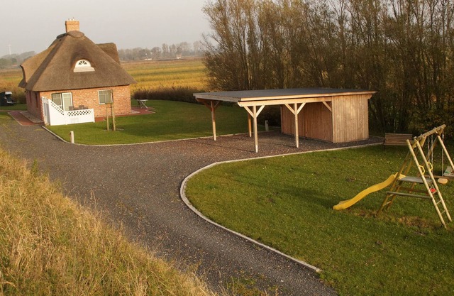 Modern furnished cottage with thatched roof in a quiet location.