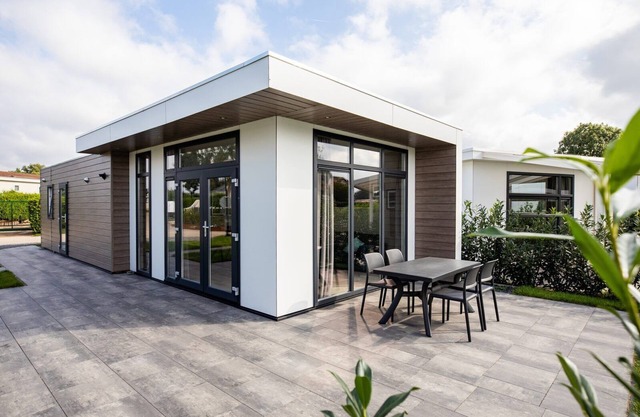 Modern holiday home with a view of a tranquil pond