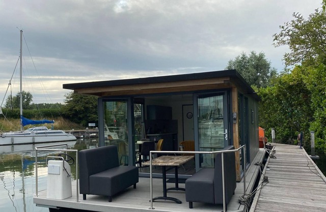 Modern house boat in Monnickendam with jetty