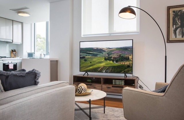 Modern Retreat with Balcony & Parking, Near Trains