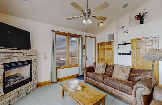 Mountain-view condo with private hot tub, balcony, pool, fireplace, streaming