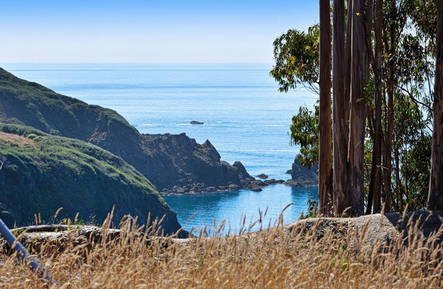 Ocean view home with free WiFi, private hot tub, furnished deck, & gas grill