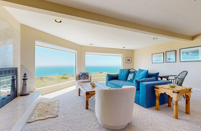 Oceanfront house with shared pool, private hot tub, modern decor, & meadow views
