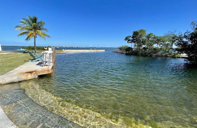 Old Florida Style, wrap around porch, boat basin for dockage, open water