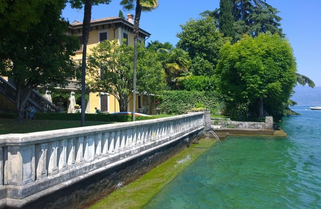 Old luxury villa with garden in front of the Garda lake