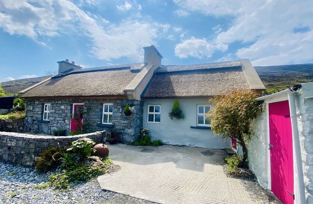 Old Thatch Cottage in the Burren views over Galway Bay on the Wild Atlantic Way