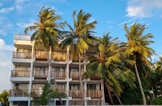 Overlooking ocean that meets cloudless sky, Coral Inn is a sanctuary of serenity