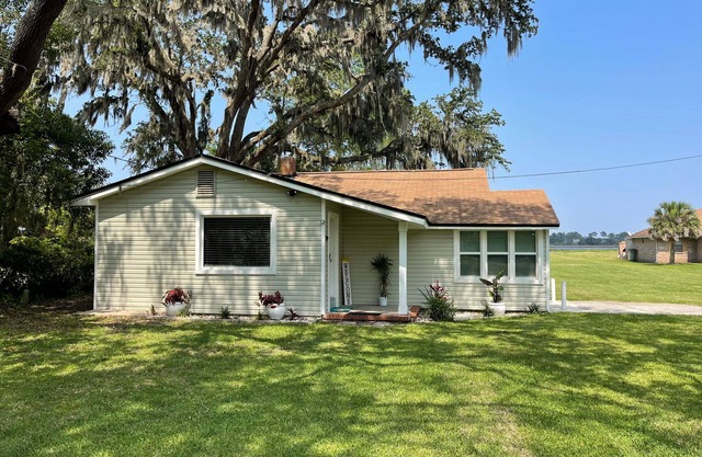 Peaceful Riverfront Cottage with a dock on 1.5 Acres.
