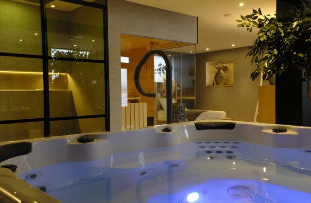 Relax in Wellness Room with Sauna and Spa Bath and luxurious outdoor seating.