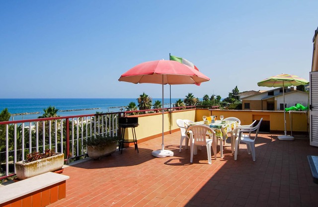 Relax with a cool drink on your terrace overlooking the sea.