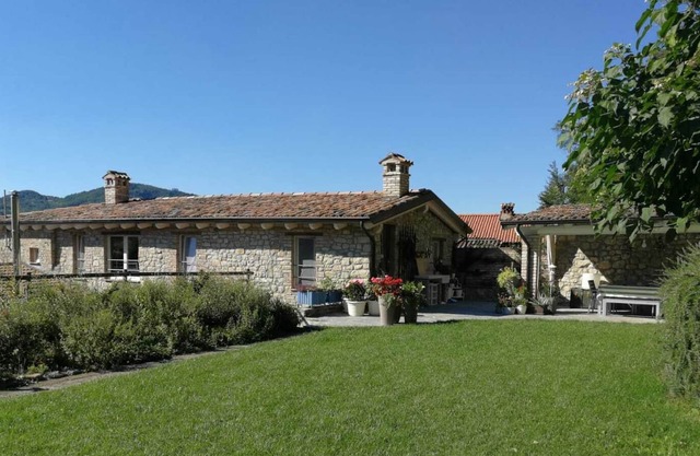 Renewed old stone house of 240 squared meters with porches garden and woods