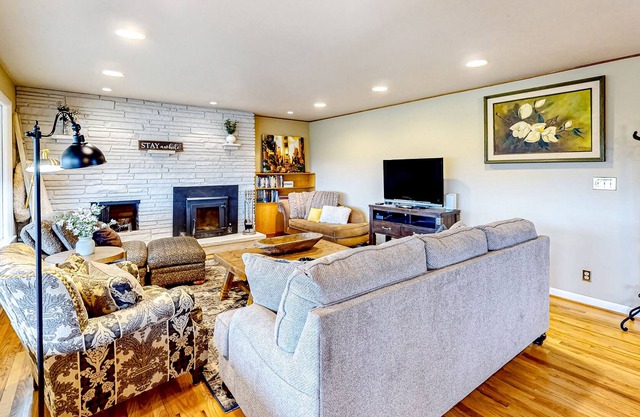 River-view home with yard, enclosed porch, wood stove, & private W/D