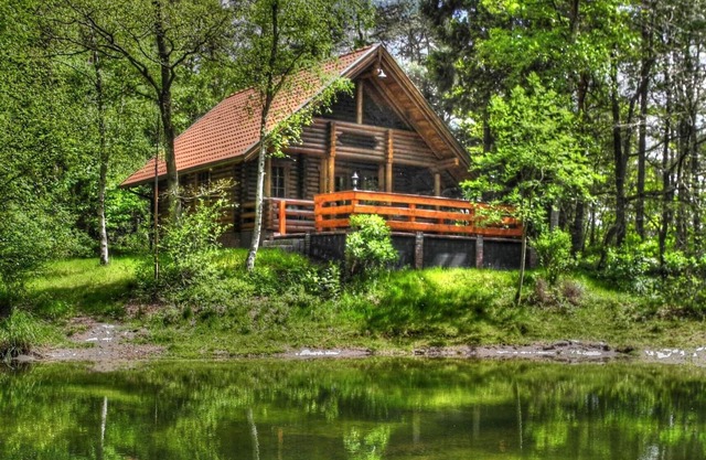 Romantic log house on a small idyllic forest lake