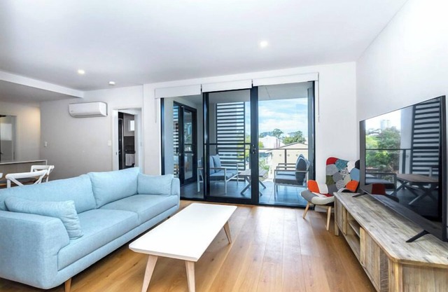 Rooftop Sky Lounge has a daybed, tables and stools, a lounge area with a big screen TV and a grassed