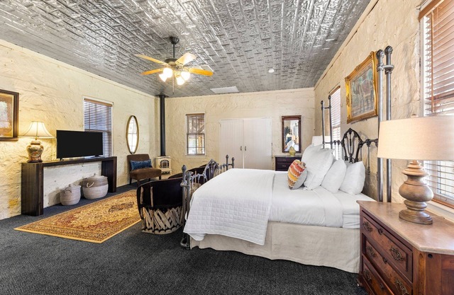 Room with One King Bed, microwave, mini-fridge, and porch
