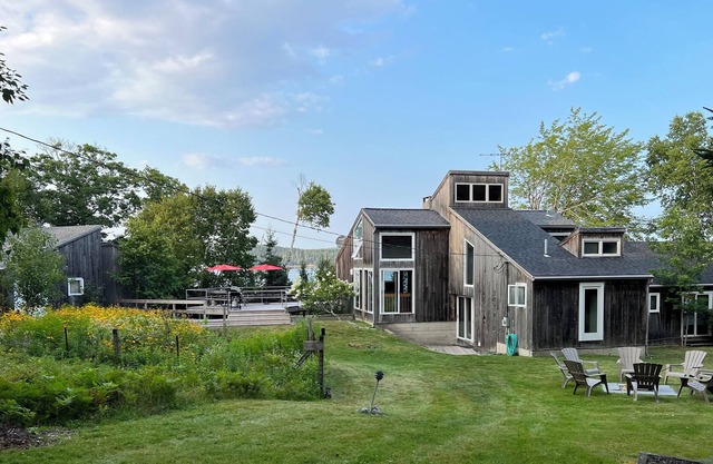Rustic home with guest houses along a private beach in Little Deer Isle, Maine.