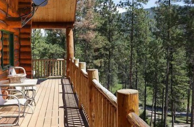 Rustic, spacious, log home nestled into the hillside of 2 acres near river access.