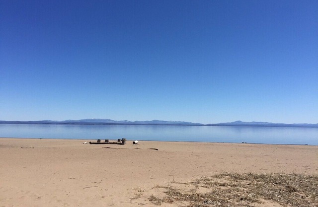 Sand beach patio edge to shoreline, spectacular mountain views, beach bonfires!