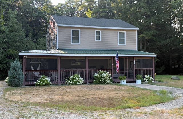 Secluded lake house with water access at public beach just 400 steps away