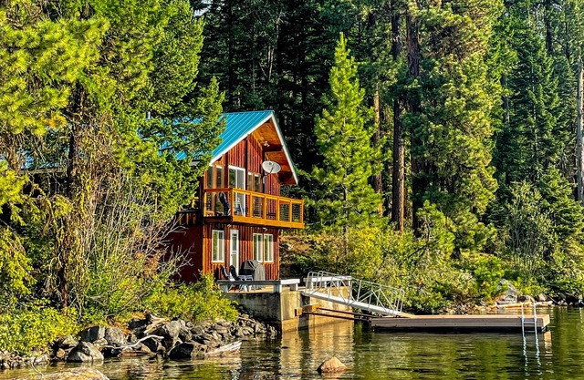 Secluded waterfront home with spacious deck & stunning views of lake & mountains