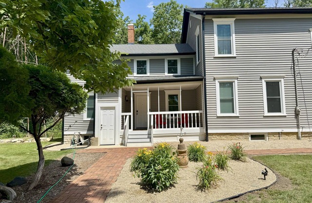 Spacious 5-bedroom farmhouse in charming Oswego with private woods