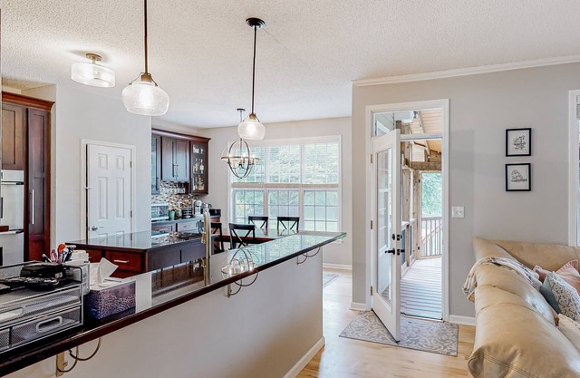 Spacious home with a covered deck, hot tub, firepit, grill, playroom, W/D, & AC