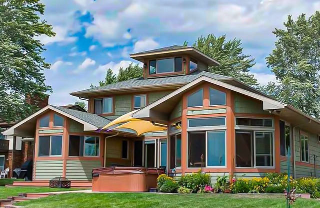 Spacious lakefront home with a hot tub, private beach, washer/dryer, & AC