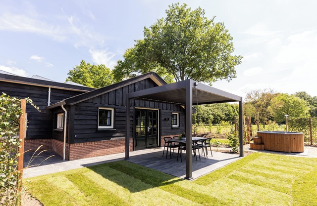 Spacious wellness home for 6 guests with a private sauna and hot tub in the garden. Stylish, single-floor layout and designed for pure relaxation.