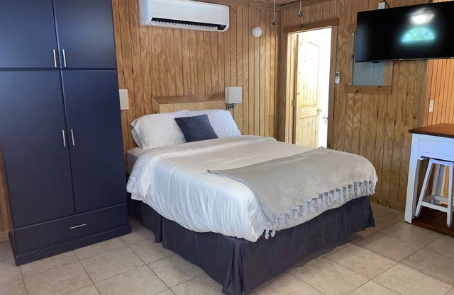 Studio cabin #3 with lake view and boat dock access, outdoor seating.
