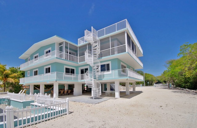 Stunning Three Level House on Key Largo Canal with a heated pool and roof deck.