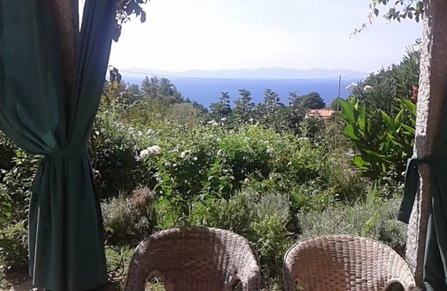Sunset over Corsica. Detached house surrounded by greenery, sea view.