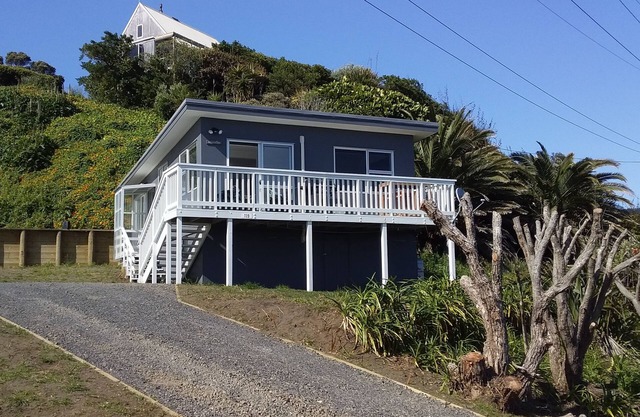 The beach front bach with ocean views!