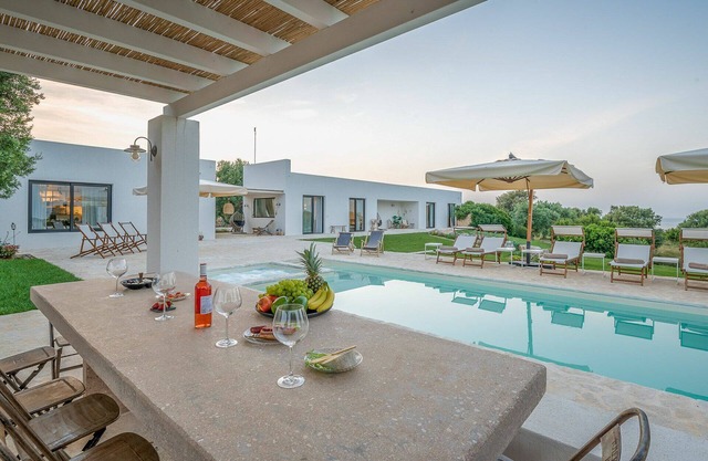 The front door, located at the side of the central body of the villa, opens into the living room.