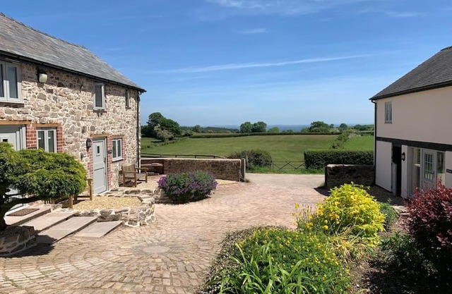 The Granary at Pentregaer Ucha, tennis court & lake.