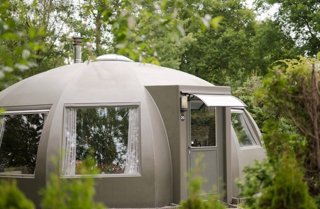 These detached bungalows with domed roofs are scattered in a wooded resort.