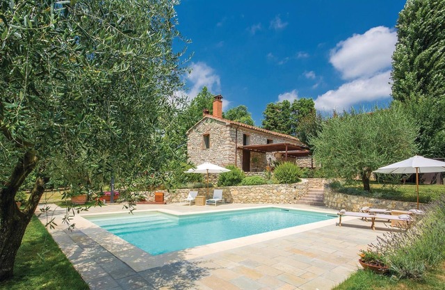 This characteristic vacation home, surrounded by a large, well-kept fenced garden, is located in the